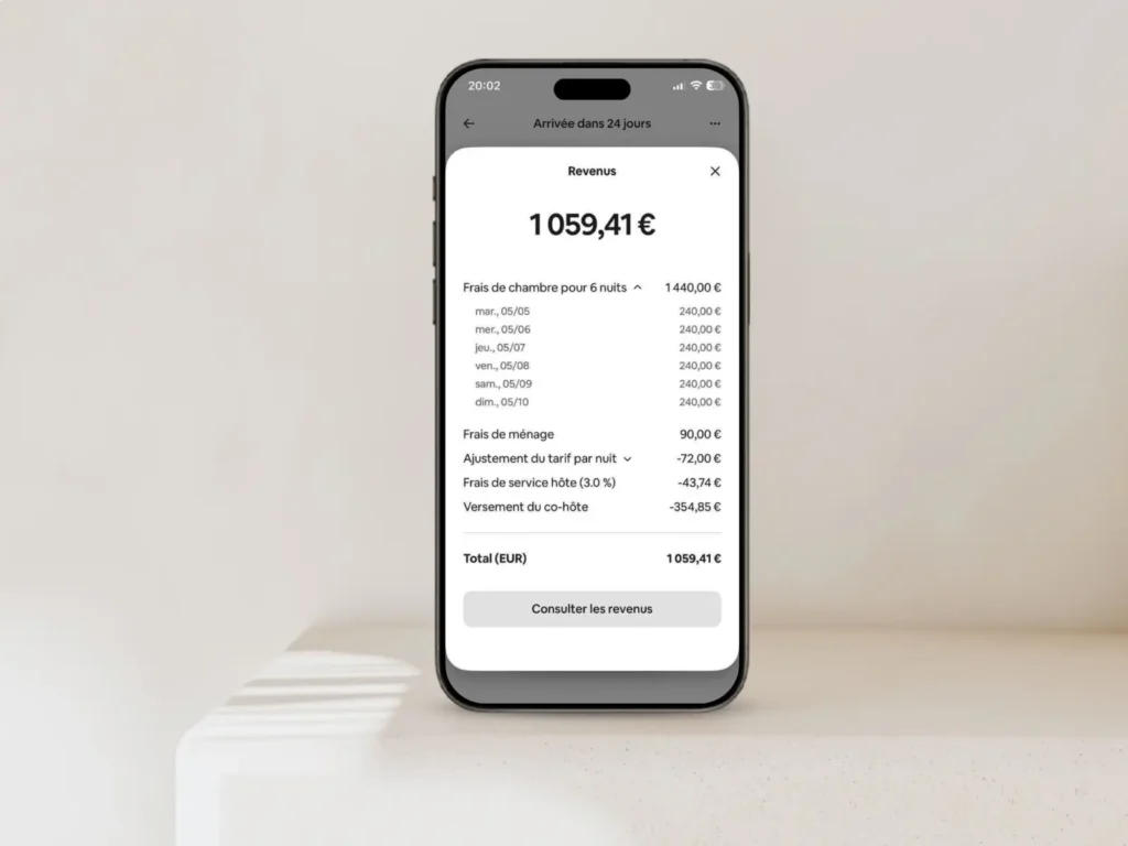 Téléphone avec vue sur le total des revenus d'un logement en location sur airbnb